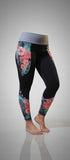 Women's hibiscus tights with island-inspired floral print, front pockets, and back zipper pocket made of nylon/spandex and polyester